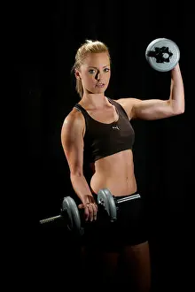 Physique Prints: Beautiful blonde girl in keep-fit outfit and working out in a studio