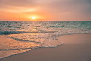 Beautiful cloudscape seascape, sunrise sunset view. Calm sea waves splashing on soft sand, relaxing nature beach, tranquil summer landscape, inspire