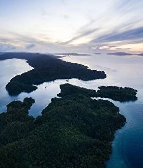 Aerial Landscape Collection: Beautiful coral reefs fringe remote limestone islands in Raja Ampat, Indonesia
