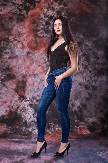 Curvy Prints: Beautiful Curvy woman Posing in Black Shirt and Jeans on a marble multi-colored background