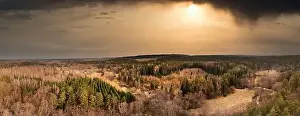 Sunburst Prints: Beautiful dramatic sunset with dark clouds and sun in countryside shot from a drone