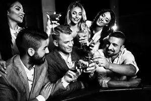 Multi Ethnic Group Prints: Beautiful and Well Dressed Couple Playing Roulette in the Casino and Drinking Alcohol to Celebrate