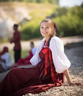 Slavic Prints: A beautiful girl in Russian national costume pose for the camera on the background of an amazing landscape