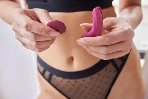 Black Beauty Prints: beautiful girl in sexy clothes holding in her hands a sex toy for adults