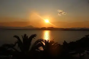 Calm Sea Prints: A beautiful golden sunset over calm sea waters
