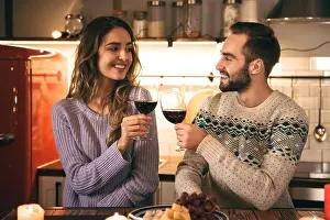 Wineglass Prints: Beautiful happy young couple spending romantic evening together at home