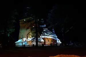Lapland Prints: Beautiful illuminated wooden church photography in the night winter full of snow Tylicz Poland