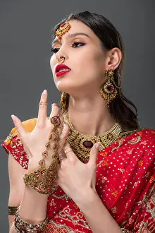 Saree Prints: beautiful indian woman posing in traditional sari and accessories, isolated on grey