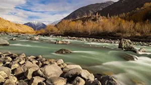 Flowing Water Prints: A beautiful landscape of Indus River flowing with rocks in the middle and foreground