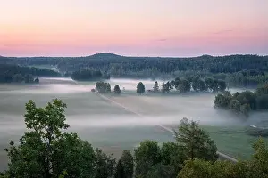 Beautiful landscape view with fog and meadow at summer evening in countryside, Finland