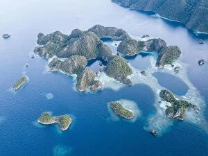 Images Dated 12th November 2017: Beautiful limestone islands rise from the calm seas of Raja Ampat, Indonesia