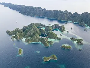 Equator Prints: Beautiful limestone islands rise from the calm seas of Raja Ampat