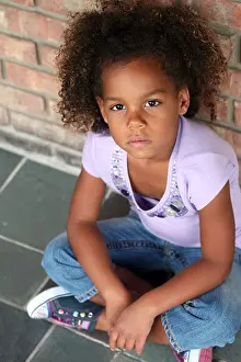 beautiful little african-american girl seated in natural light