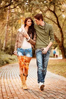 Flirting Prints: Beautiful lovely couple walking and enjoying in the park in autumn colors