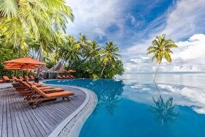 Images Dated 1st November 2019: Beautiful luxury hotel pool resort beach, palm trees, loungers with umbrella