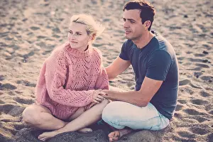 Stay Prints: beautiful model couple caucasian young lady and man stay in love hugging and sitting on the beach