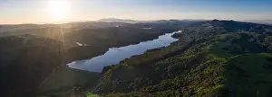 A beautiful morning lights the green hills around the San Pablo Reservoir in Northern California. A wet winter has caused lush vegetation growth