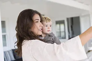 Beautiful Woman Prints: Beautiful mother and cute son taking selfie at home