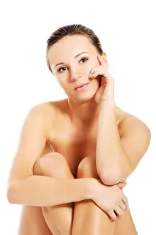 Beautiful naked woman sitting. Isolated on white