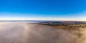 Village View Prints: Beautiful panorama of winter village covered with dense fog from aerial view 2020