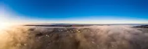Village View Prints: Beautiful panorama of winter village covered with dense fog from aerial view 2020