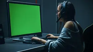 Gamer Prints: Beautiful Professional Gamer Girl Playing in Video Game on Her Personal Computer with Green Screen Mock-up Temlate