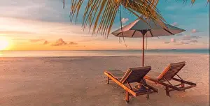 Sunset Landscape Prints: Beautiful relax beach. Chairs on the sandy beach near the sea