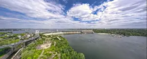 The beautiful river is surrounded by green and fresh vegetation in the city