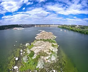 The beautiful river is surrounded by green and fresh vegetation in the city