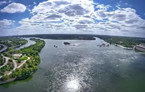The beautiful river is surrounded by green and fresh vegetation in the city