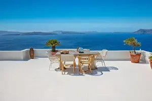 Beautiful Santorini landscape with white architecture and sea view. Sunny summer travel luxury background, cityscape, urban scenic. Idyllic streets