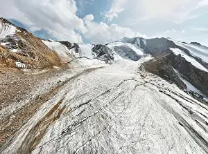 View Peak Prints: Beautiful scenery of the ice glacier with crack and snow cap of mountains near Almaty city