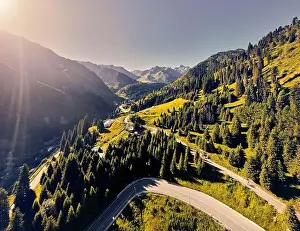 Beautiful scenery of the mountains with snow glacier and road and river at sunrise sky in Almaty