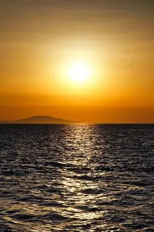 Glittering Prints: Beautiful shiny warm color sunset above wavy sea surface aerial view