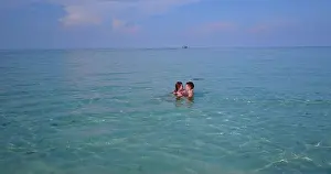 Honeymoon Prints: Beautiful shot of a couple hugging each other in turquoise water of Maldives