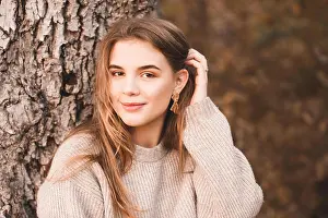 Beautiful smiling blonde girl 16-18 year old posing outdoors. Looking at camera. Teenagerhood