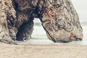 Stone Bridge Prints: Beautiful stone natural arche. Rock formation in a beach with ocean in background