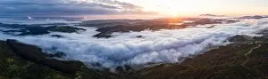 Mountain Biking Prints: A beautiful sunrise illuminates fog as it rolls through valleys in Northern California