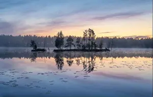 Reflection Lake Prints: Beautiful sunrise landscape with misty mood and calm lake at foggy summer morning in Finland