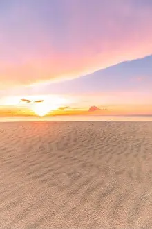 Beautiful sunset on the beach and sea. Tropical beach at beautiful sunset. Nature background. Exotic landscape, shore, coast, calm waves, soft sand