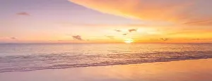 Beautiful sunset on the beach and sea. Tropical beach at beautiful sunset. Nature background. Exotic landscape, shore, coast, calm waves, soft sand