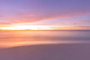Beautiful sunset on the beach and sea. Tropical beach at beautiful sunset. Nature background. Exotic landscape, shore, coast, calm waves, soft sand