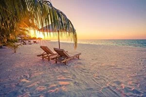 Images Dated 5th January 2017: Beautiful sunset relax beach. Chairs on sandy beach near the sea
