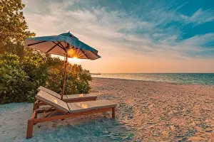 Sunset Landscape Prints: Beautiful sunset relax beach. Chairs on sandy beach near the sea