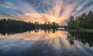 Beautiful sunset in tranquil lake at summer evening in Finland