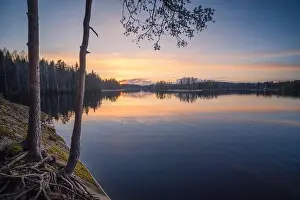 Beautiful sunset in tranquil lake at summer evening in Finland