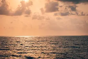 Beautiful sunset over the tropical sea. Beautiful landscape outdoor sea ocean and beach at sunrise or sunset. Idyllic relaxing ecology, endless ocean