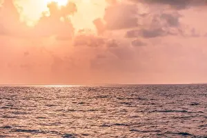 Beautiful sunset over the tropical sea. Beautiful landscape outdoor sea ocean and beach at sunrise or sunset. Idyllic relaxing ecology, endless ocean