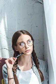 Braids Prints: beautiful thoughtful teen girl with braids in eyeglasses