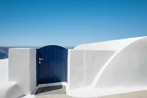 Beautiful travel background for vacation holiday banner. White houses in the town of Oia on the island of Santorini, panorama. Amazing scenic views